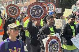 Members of the Laborers Union march in a No Kings demonstration, holding signs that say Immigrant Rights Are Workers Rights and An Injury to One Is an Injury to All.
