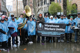 Bergen logistics workers and supporters gather in blue rain ponchos. 