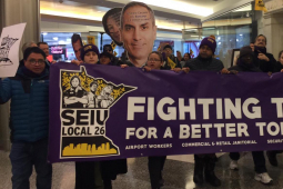 Commercial office janitors, retail janitors, security officers, window cleaners, and airport workers march through the downtown Minneapolis skyway, carrying a banner that reads "Fighting Today for a Better Tomorrow," as part of SEIU Local 26's contract campaign.