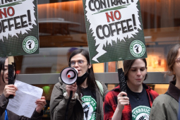 workers march with “no contract, no coffee” signs, one with a megaphone