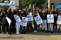 Thirty Black workers stand with signs saying “ATU on Strike”