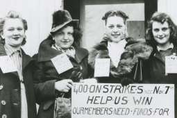 Five women in a black and white photo hold a sign saying “400 on strike since November 7 Our members need funds”