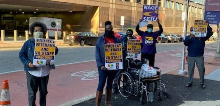 four protesters hold signs: "PROTECT VETERANS AND VA STAFF #VACOVID" AND "NAGE SEIU"