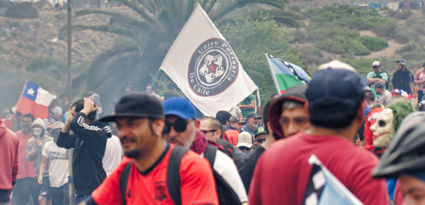 Chilean protesters gathered near a flag.