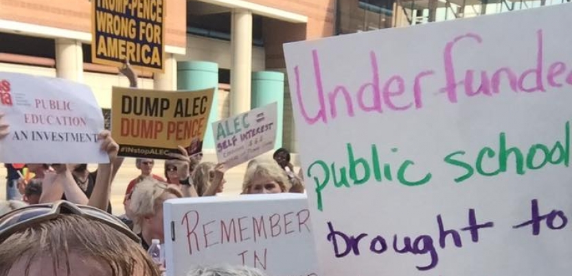 Members of the Maconaquah Education Association hold up signs to support teachers and public education.