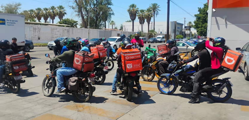 Workers stand by on their motorcycles. 