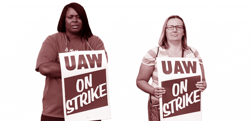 Two UAW workers with picket signs