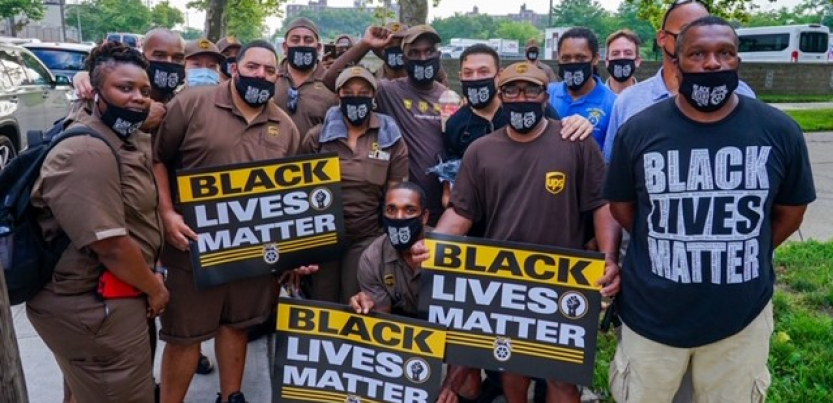 crowd of workers, many in brown UPS uniforms, with "Black Lives Matter" signs