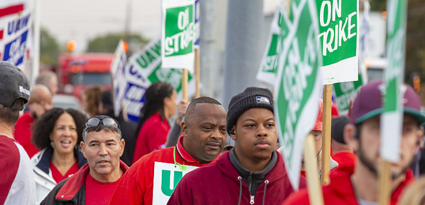 UAW workers marching with picket signs.