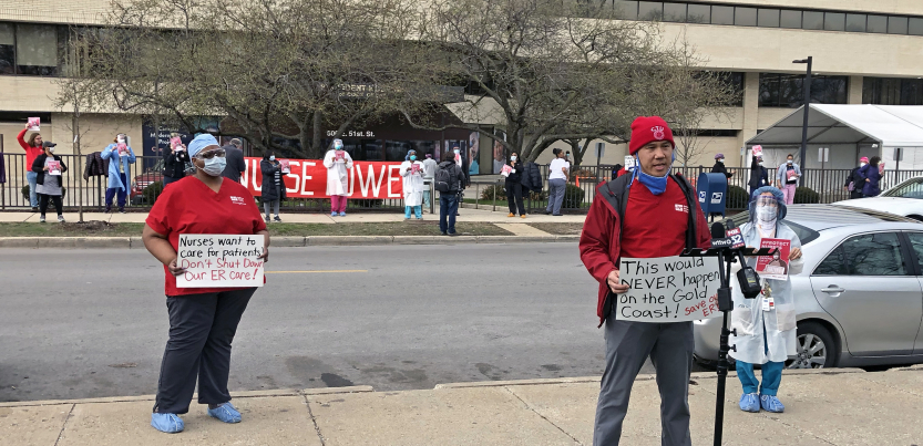 Nurses hold signs and demonstrate outside of Provident Hospital in Chicago.