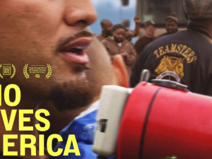 Close-up of a man's chin with bullhorn and the back of someone's Teamsters jacket in a crowd. Overlaid in yellow type is the movie title: Who Moves America.