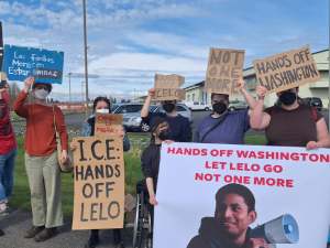 Supporters gather at a rally demanding Alfredo's release with signs reading "ICE Hands off Lelo", "Chinga la Migra" and other statements in solidarity with Lelo.