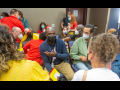 People in masks talking in a group during a workshop at the Labor Notes Conference