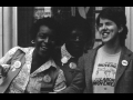 Multiracial group of activists standing next to each other and laughing.