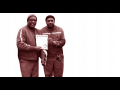 Two UPS workers holding a document.