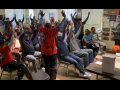 Strike authorization vote - people standing with arms raised.