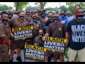 crowd of workers, many in brown UPS uniforms, with "Black Lives Matter" signs