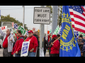 UAW strikers picketing on a street corner.