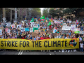 huge crowd of people, front row carries "global strike for the climate" banner