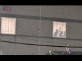 A photo taken at night shows detainees silhouetted in the prison window, one with fist raised. 