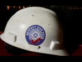 A white hardhat with a sticker that reads "Respect Our Vote."