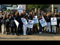 Thirty Black workers stand with signs saying “ATU on Strike”