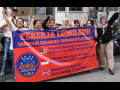 A group of supporters stand behind a red and blue banner congratulating the Lumileds workers on voting for the union and saluting their courage.