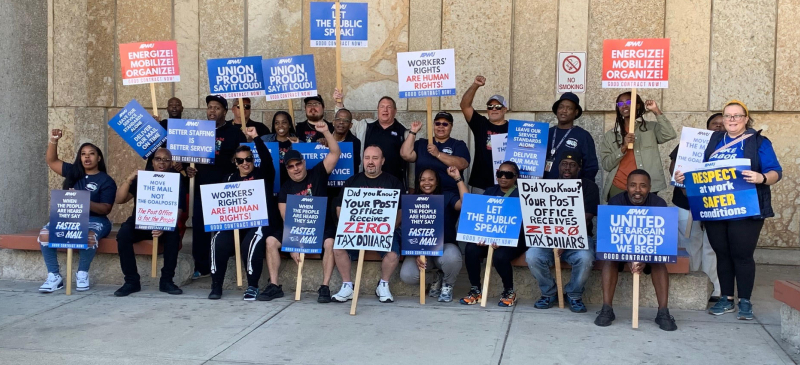 Workers gather at an APWU action