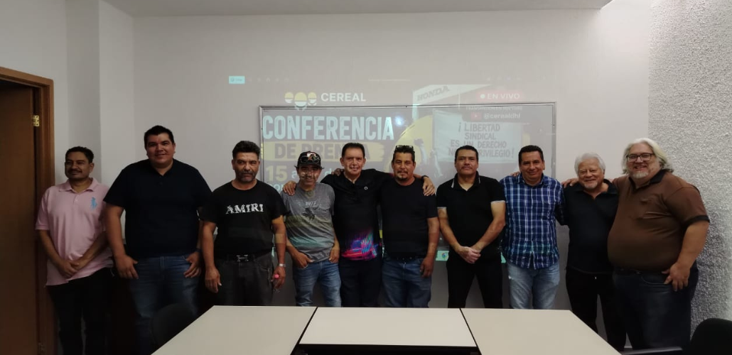 Former Honda workers gather for a photo at a press conference. 