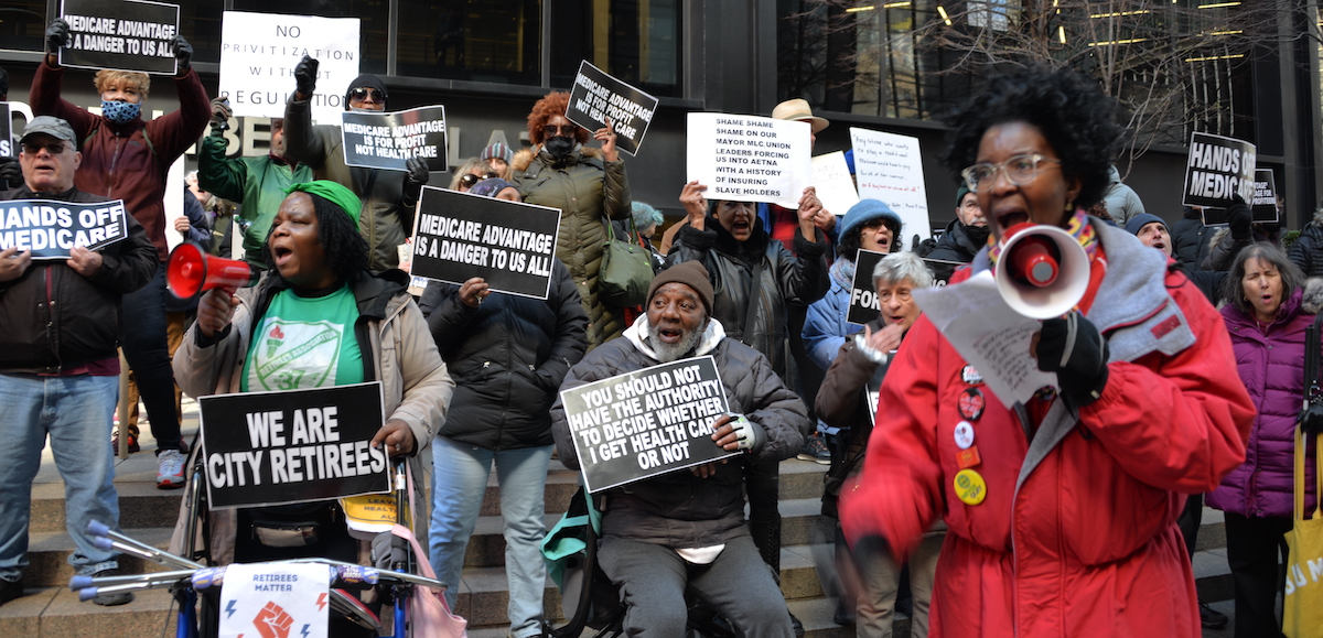 A group of retirees protest with signs saying Medicare Advantage is a Danger to Us All