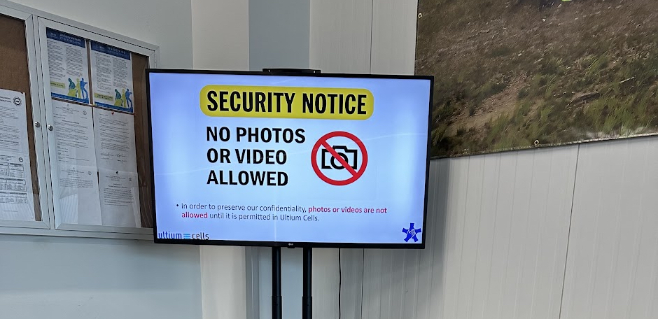 A screen at an Ultium Cells facility which says, "Security Notice: No Photos or Videos Allowed."
