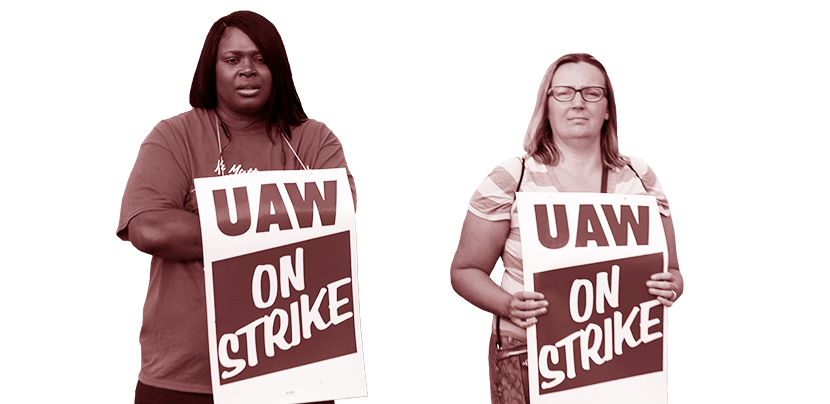 Two UAW workers with picket signs