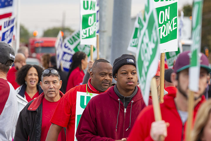 UAW workers marching with picket signs.