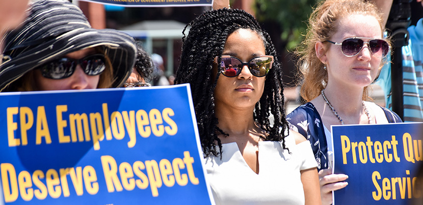 Three EPA workers protesting with signs: EPA workers demand respect. Other sign cut off.