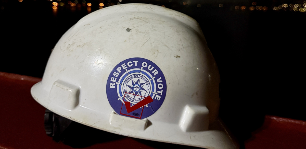 A white hardhat with a sticker that reads "Respect Our Vote."