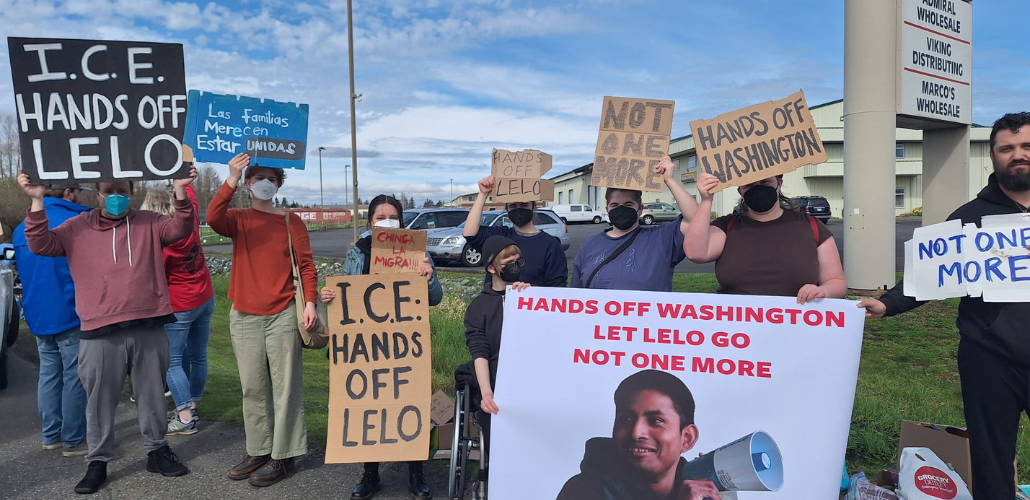 Supporters gather at a rally demanding Alfredo's release with signs reading "ICE Hands off Lelo", "Chinga la Migra" and other statements in solidarity with Lelo.