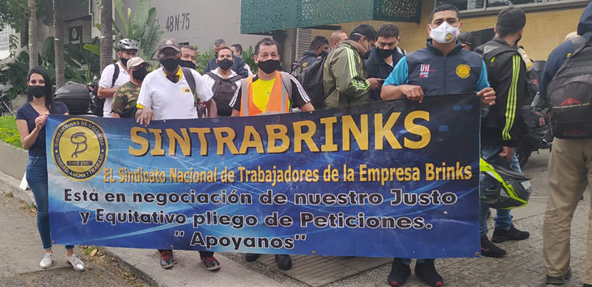 Sintrabrinks workers picketing behind a blue banner in Cali, Colombia in December 2020.