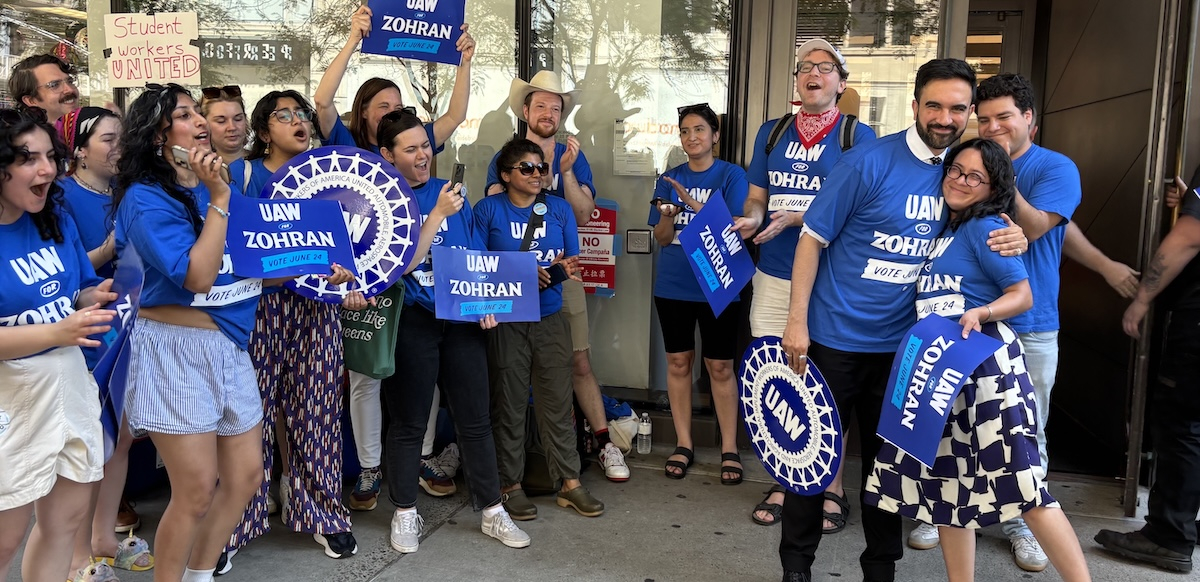 Several people in UAW for Zohran T-shirts laugh together with the candidate.