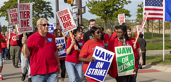 Crowd of GM workers on strike, marching.