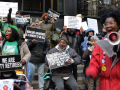 A group of retirees protest with signs saying Medicare Advantage is a Danger to Us All