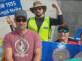 Five men in hats, sunglasses and hi-viz vests hold signs--including one that says IBEW 1555 On Legal Strike