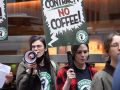 workers march with “no contract, no coffee” signs, one with a megaphone